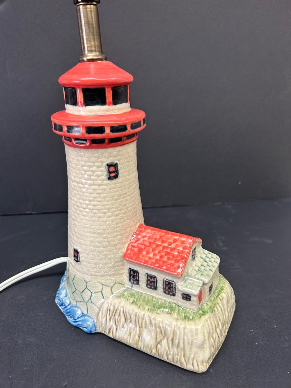 Vintage 1990’s hand painted ceramic lighthouse on a rocky coast  9” accent lamp